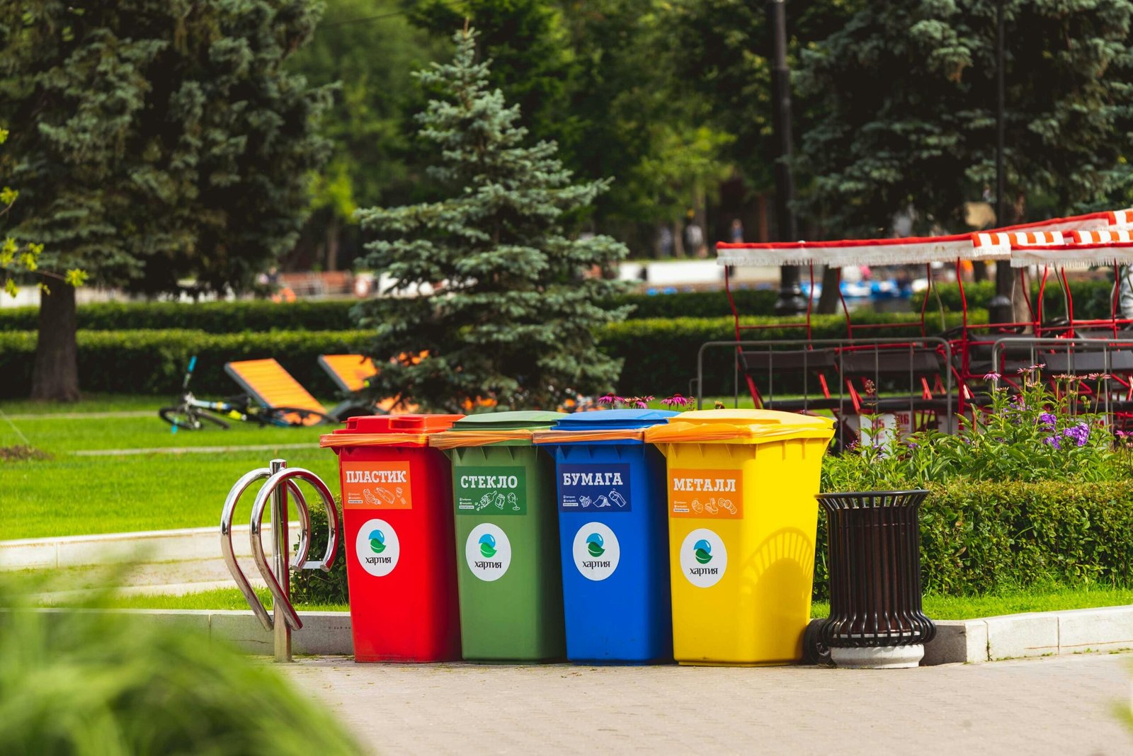 Colorful recycling bins for waste segregation in a Moscow park.